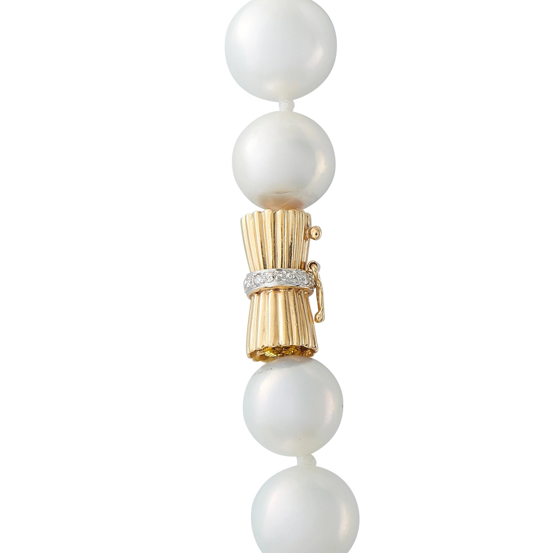 Gold clasp with pearl drops and crystal-like connector accents on necklace