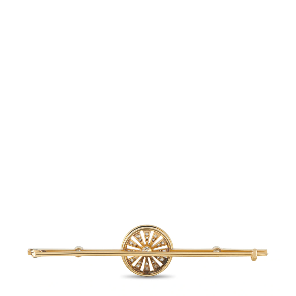 Antique gold brooch with circular sunburst center and small diamond-like stones