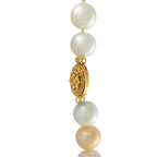 Pearl bead necklace with ornate gold oval centerpiece and linked pearl drops
