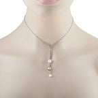 Diamond and pearl pendant necklace with V-shaped diamond bail and three pearls