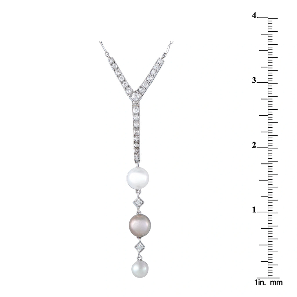 Diamond and pearl pendant with three pearls, shown next to a ruler for size