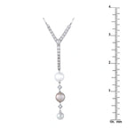 Diamond and pearl pendant with three pearls, shown next to a ruler for size