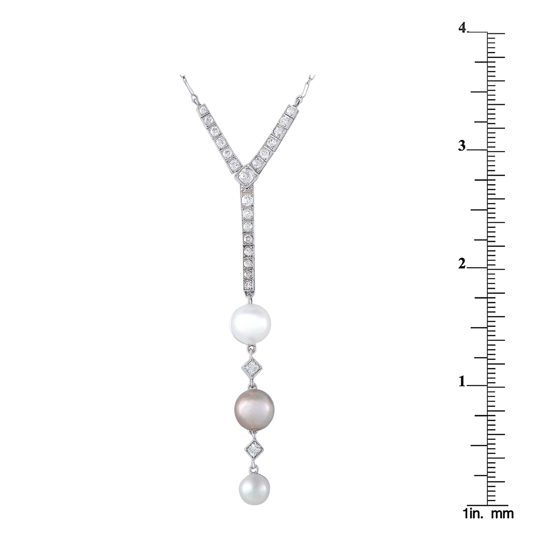 Diamond and pearl pendant with three pearls, shown next to a ruler for size