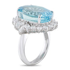 Platinum ring featuring oval aquamarine center and bright diamond clustered band