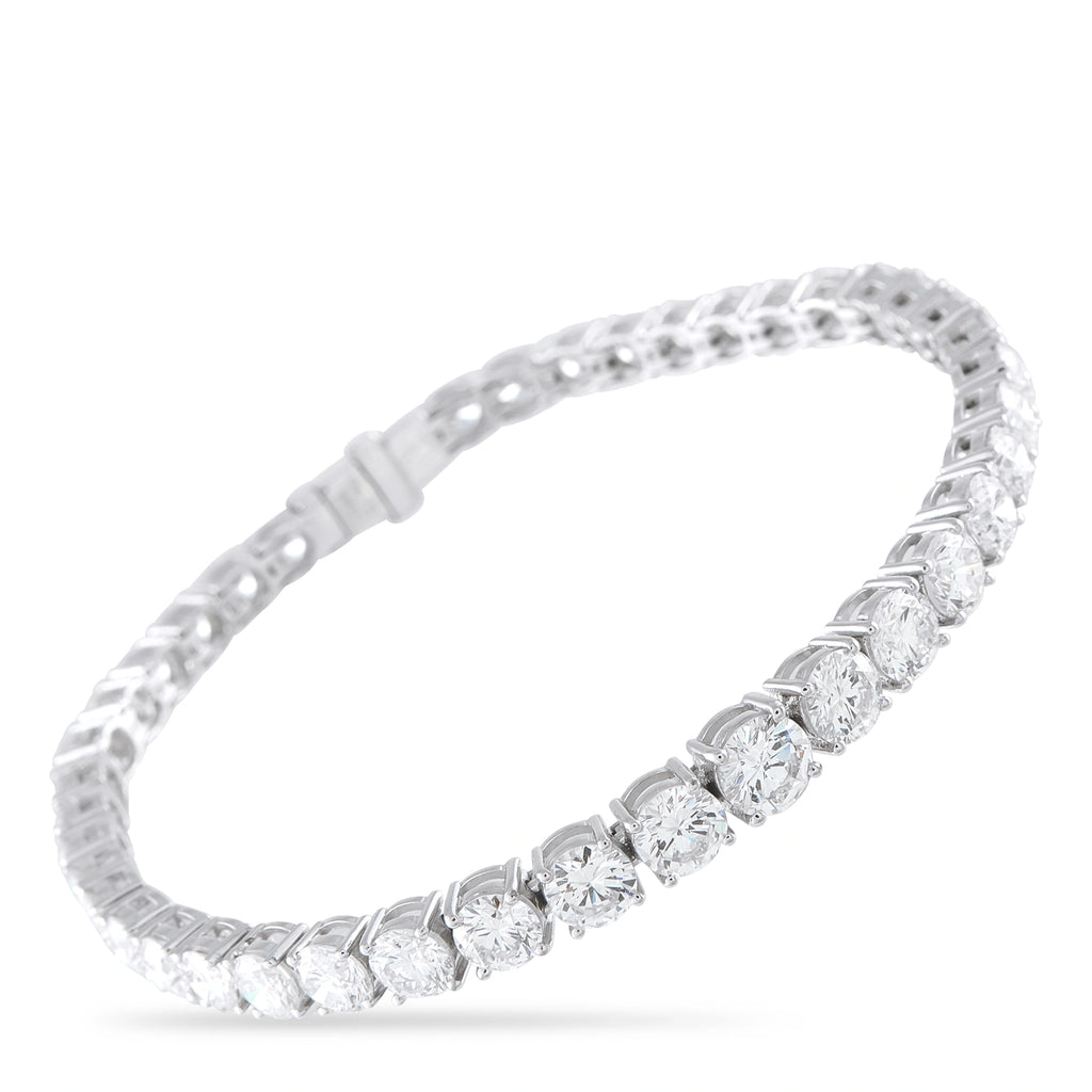 Silver tennis bracelet with round diamond-like stones in a continuous row, hinged clasp