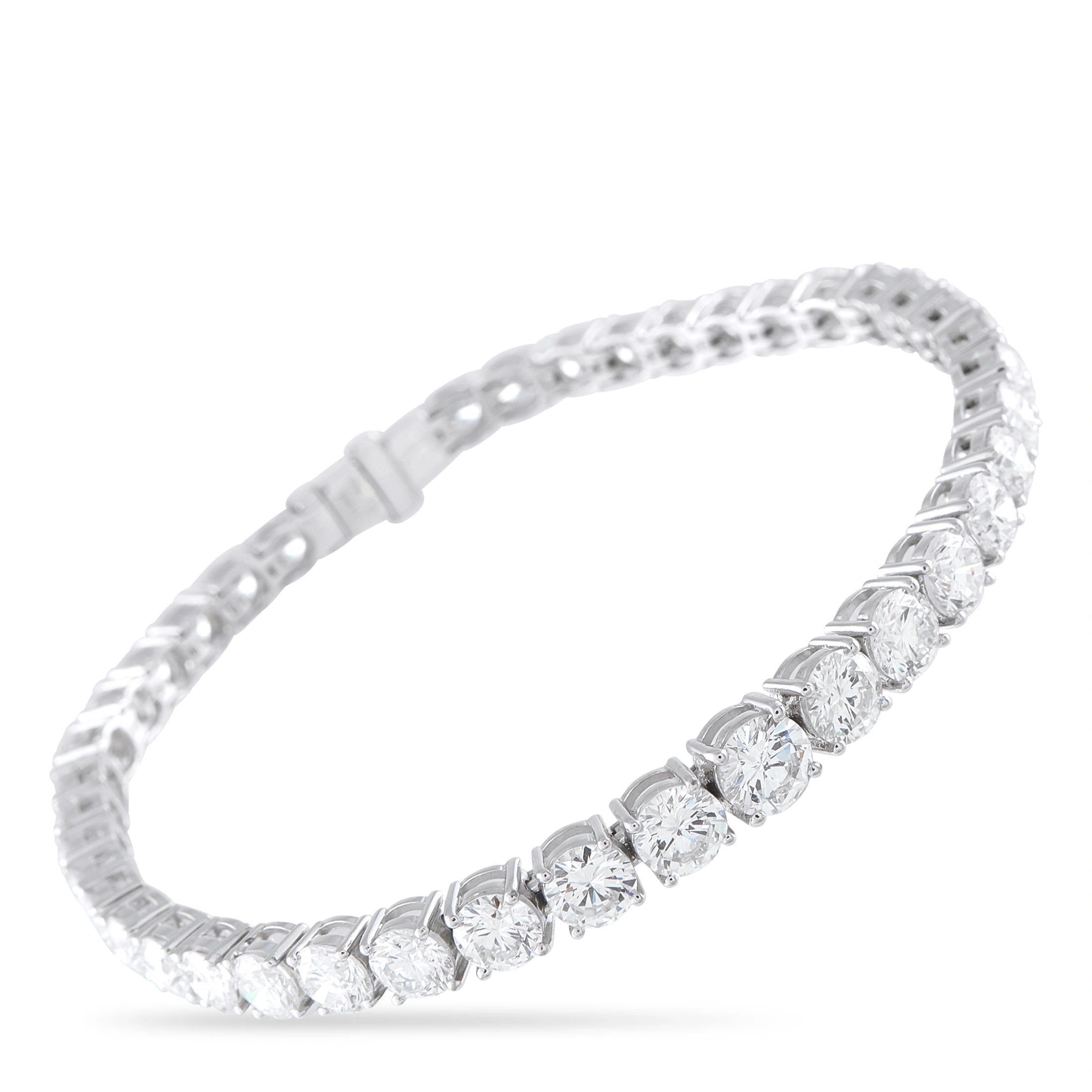 Silver tennis bracelet with round diamond-like stones in a continuous row, hinged clasp