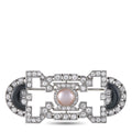 Art Deco diamond brooch with round pearl center, black onyx side panels, and geometric bezels.