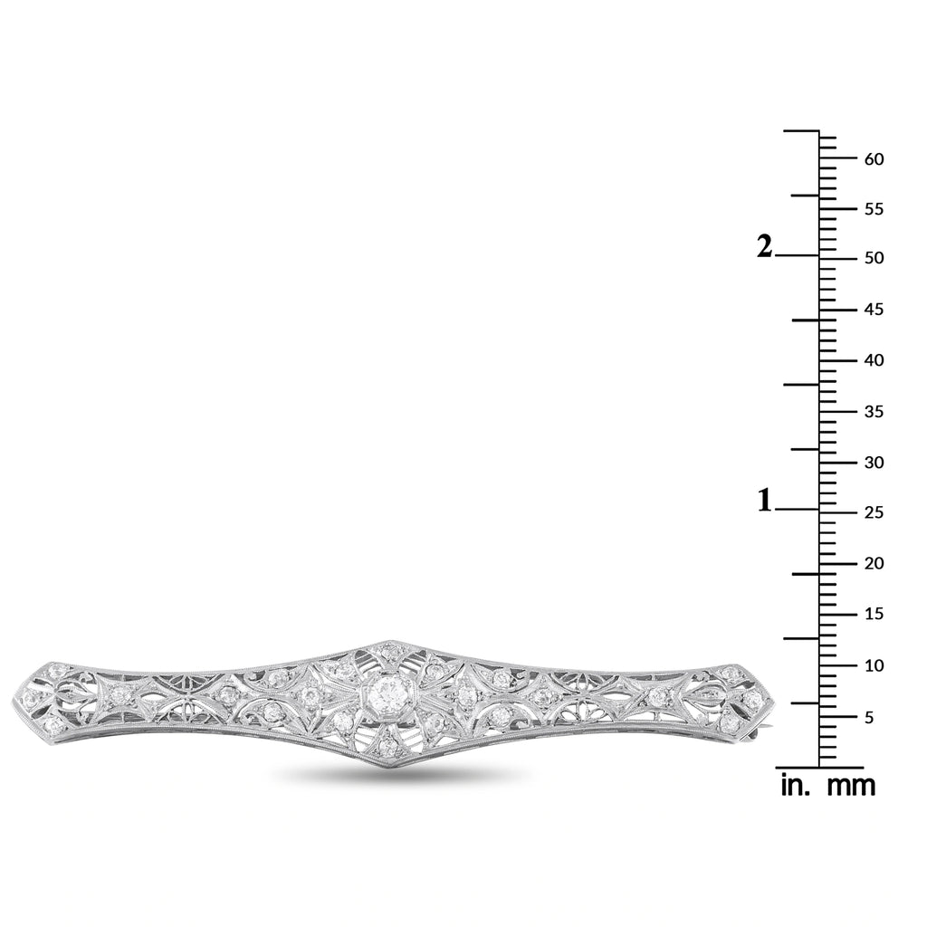 Platinum-toned diamond brooch shown with mm size scale, elongated marquise center