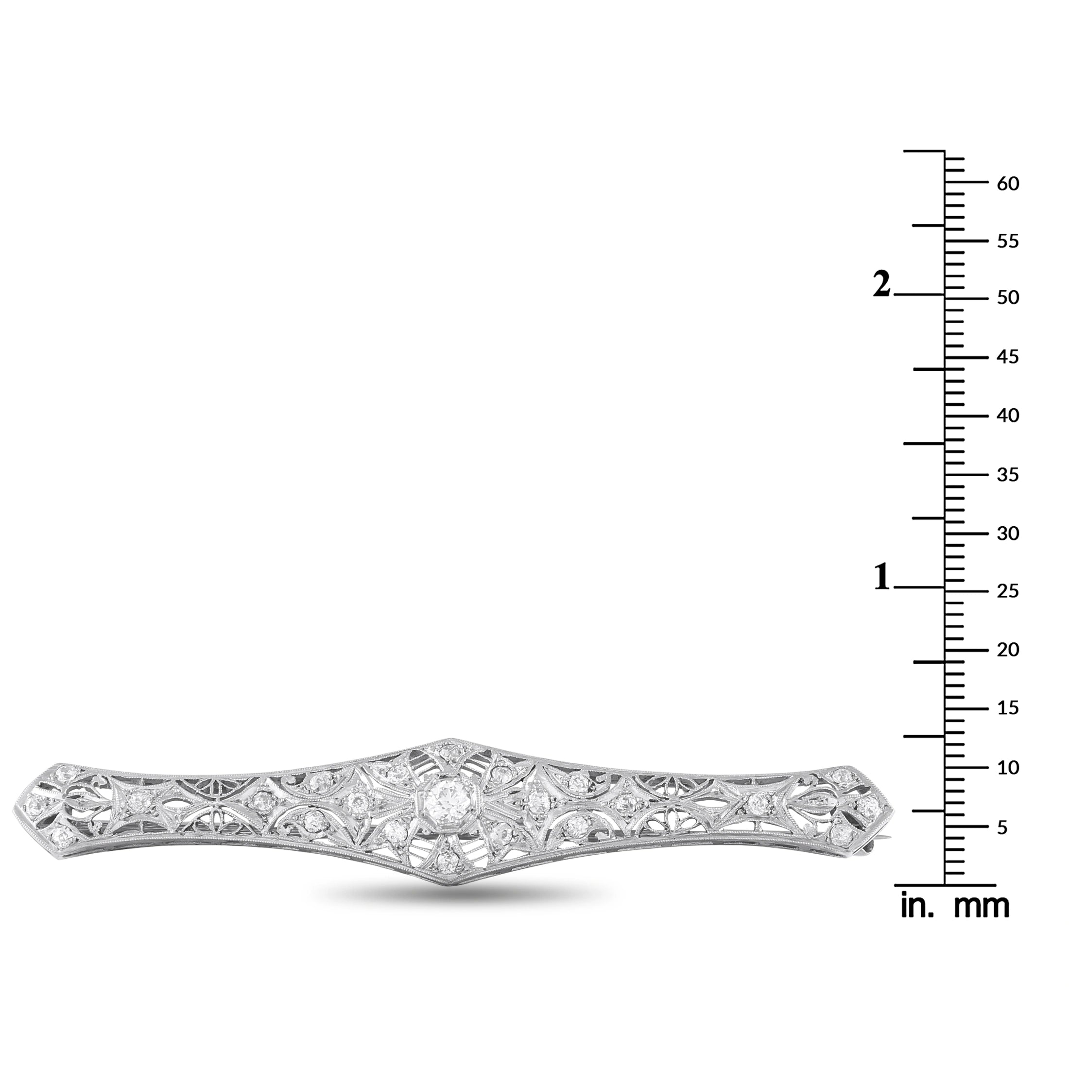 Platinum-toned diamond brooch shown with mm size scale, elongated marquise center