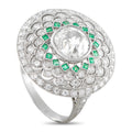 Diamond and emerald ring with round center stone, green square accents, filigree halo