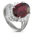 Platinum ring with oval garnet center and diamond pave halo, marquise claws