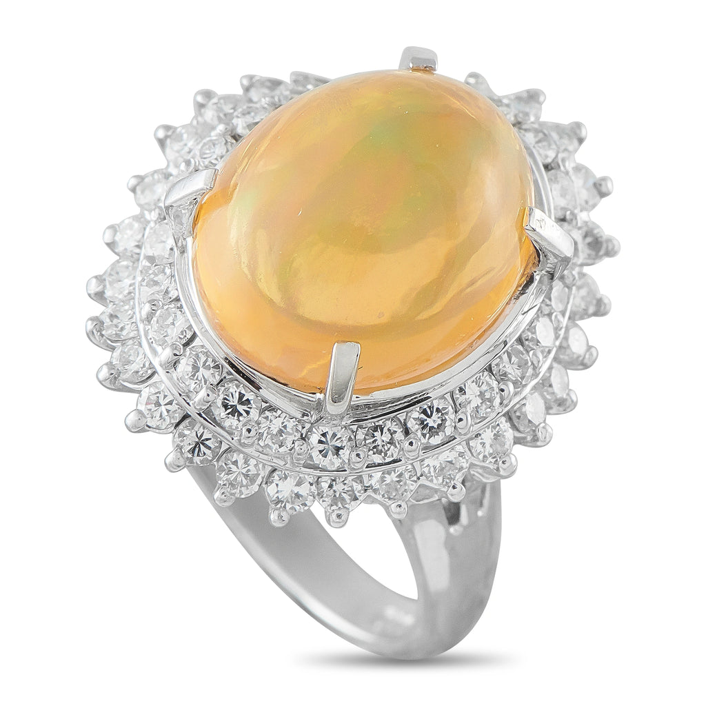 Diamond halo ring with oval orange-yellow opal cabochon in prong-set platinum