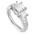 Platinum diamond ring with a rectangular center stone and three side diamonds