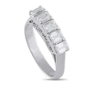Platinum diamond ring with emerald-cut stones in a straight row and openwork shank