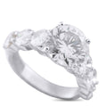 Platinum diamond ring with oval center stone and two side diamonds, prong set