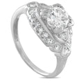 Antique diamond engagement ring with oval center stone and pave shoulders