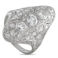 Antique platinum diamond ring with oval center stone and engraved filigree