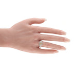 Platinum diamond three-stone halo ring on hand