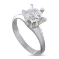 Platinum diamond engagement ring with round center stone and star-shaped prongs