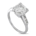 Platinum diamond ring with large round center stone and halo-like side prongs