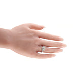 Platinum diamond ring worn on a finger, with a prominent center stone and halo
