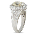 Diamond ring side view showing a raised halo setting and baguette stones along split shoulders