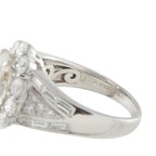 Platinum ring close-up showing engraved inner band and baguette-set split shoulders
