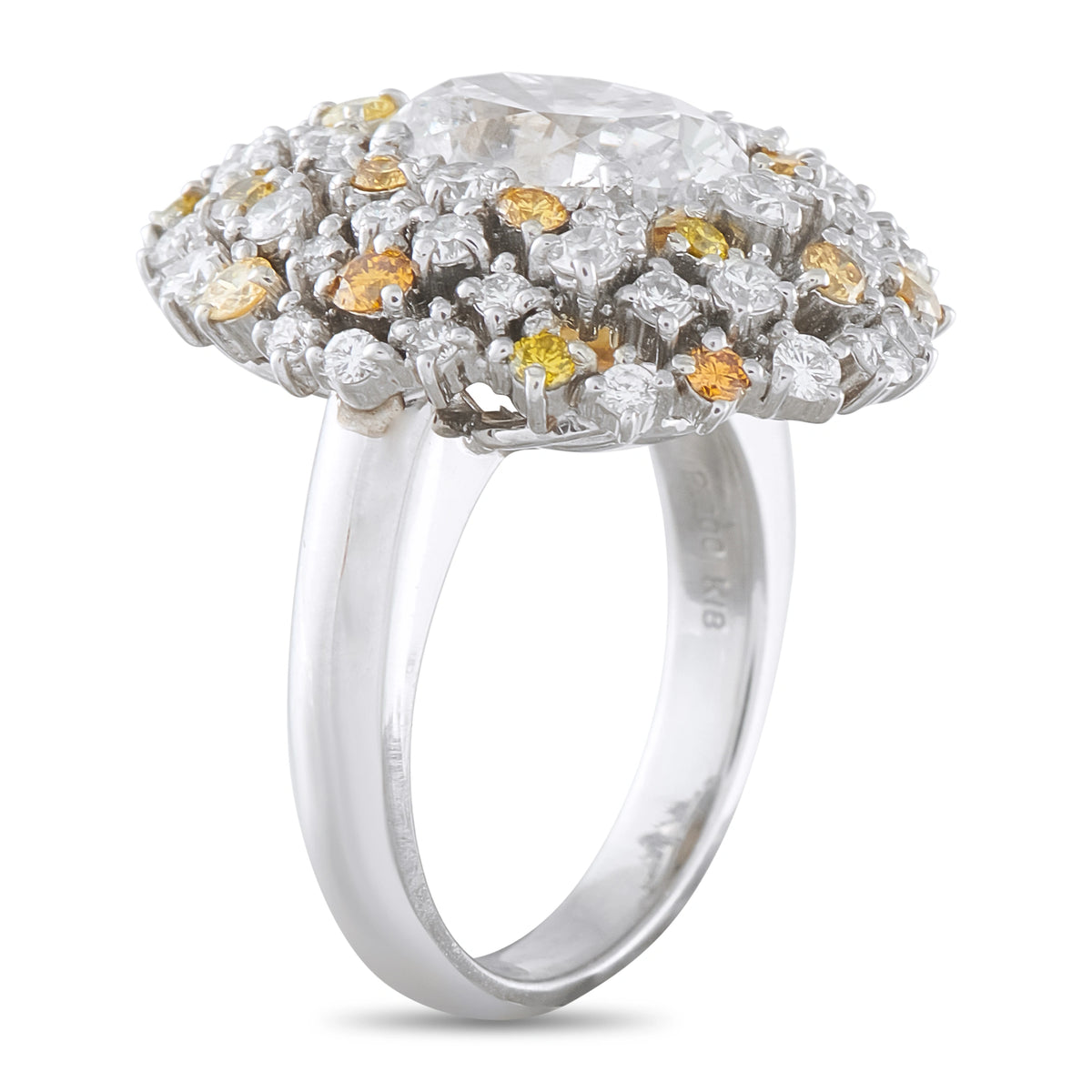 Platinum diamond ring, side view of the raised cluster setting and smooth band