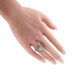 Platinum diamond ring worn on a hand, with a prominent cluster setting