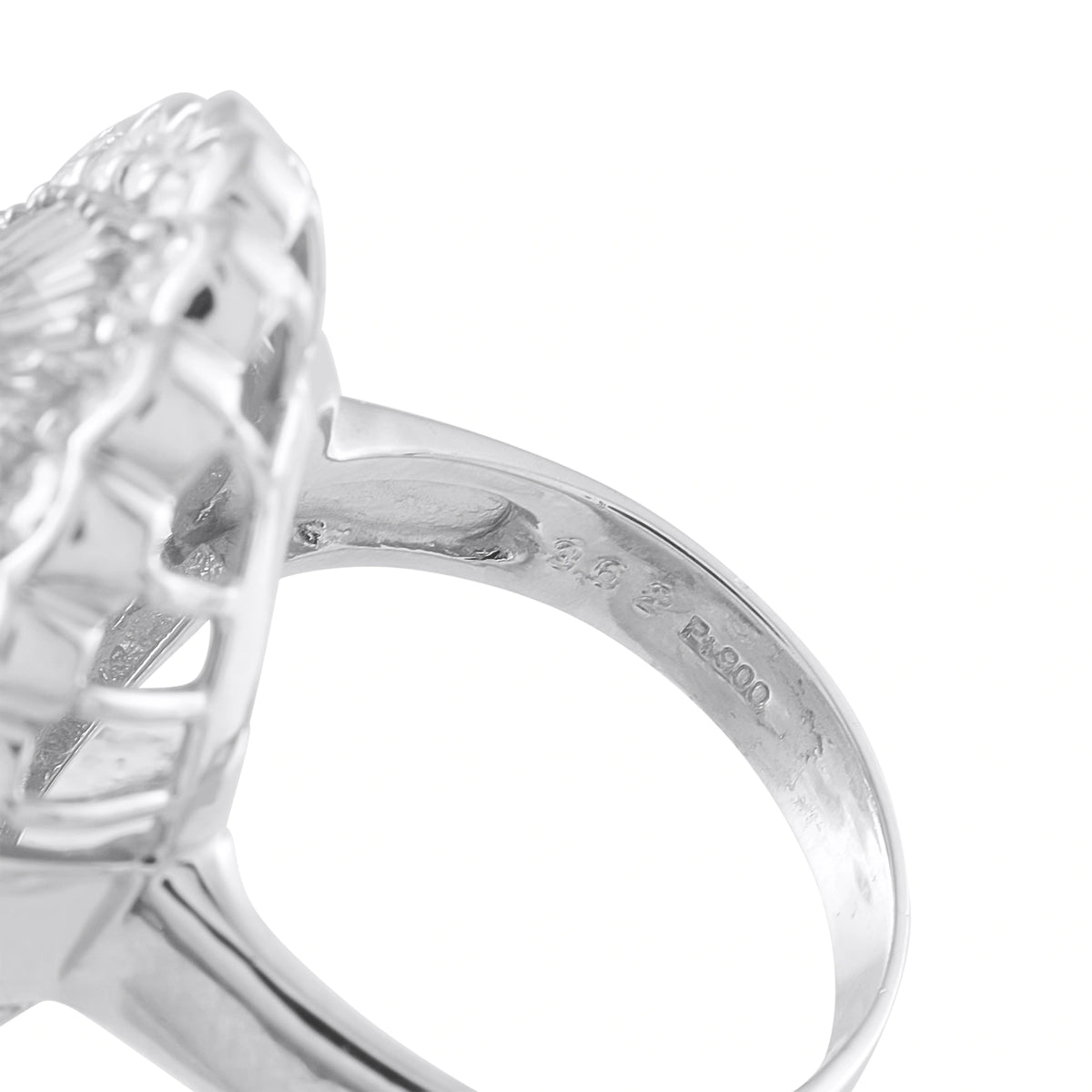 Platinum diamond ring close-up of engraved inner band and prongs