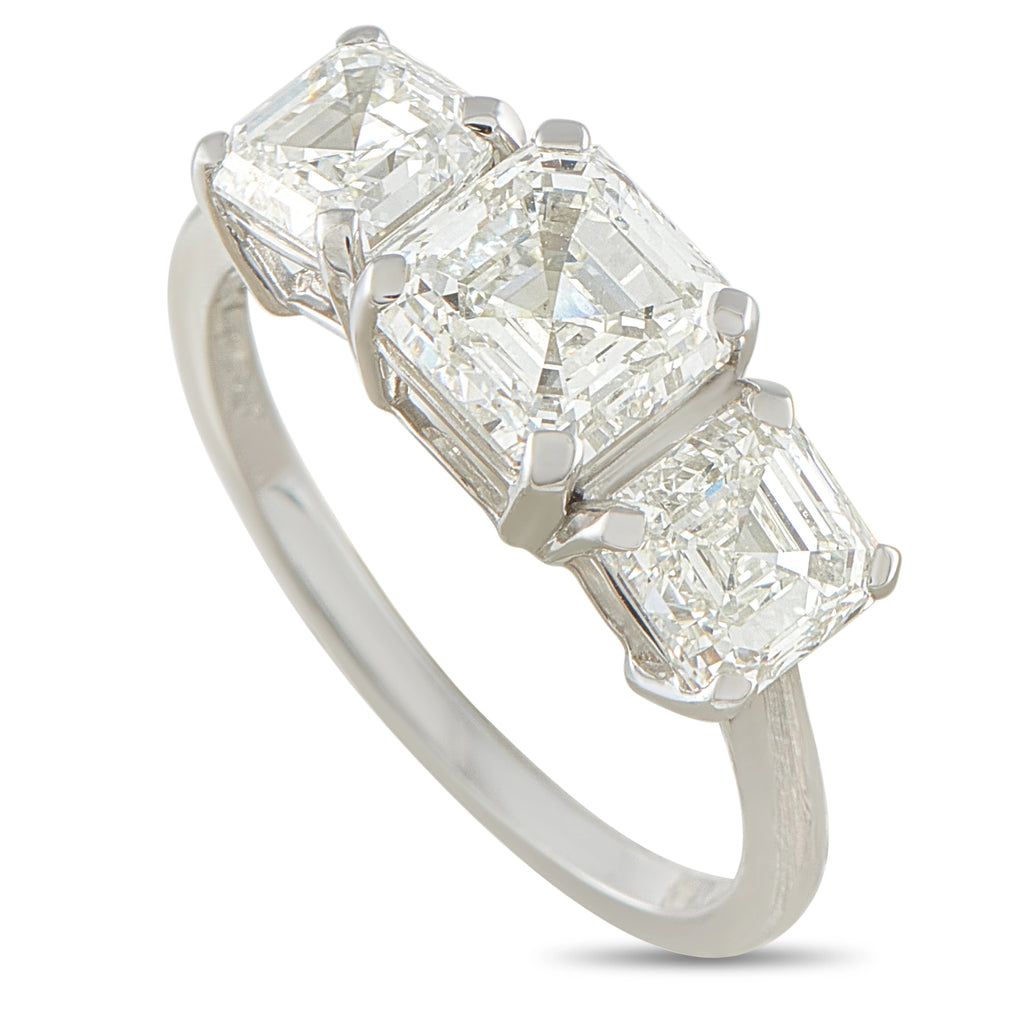Platinum diamond ring with three emerald-cut stones in a row