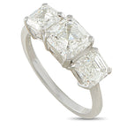 Platinum diamond ring with three emerald-cut stones in a row