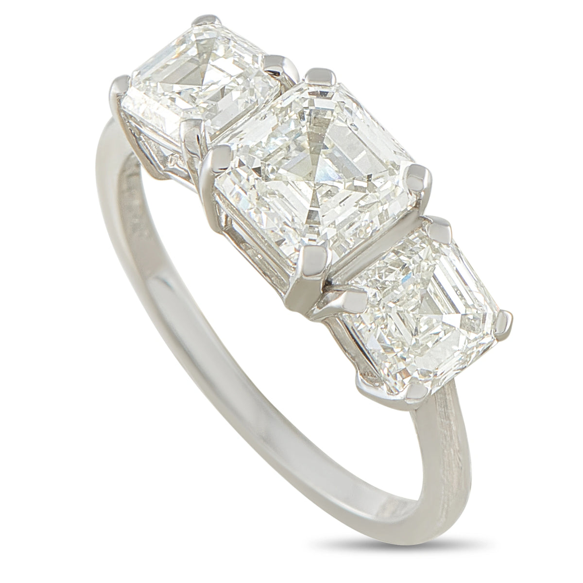 Platinum diamond ring with three emerald-cut stones in a row