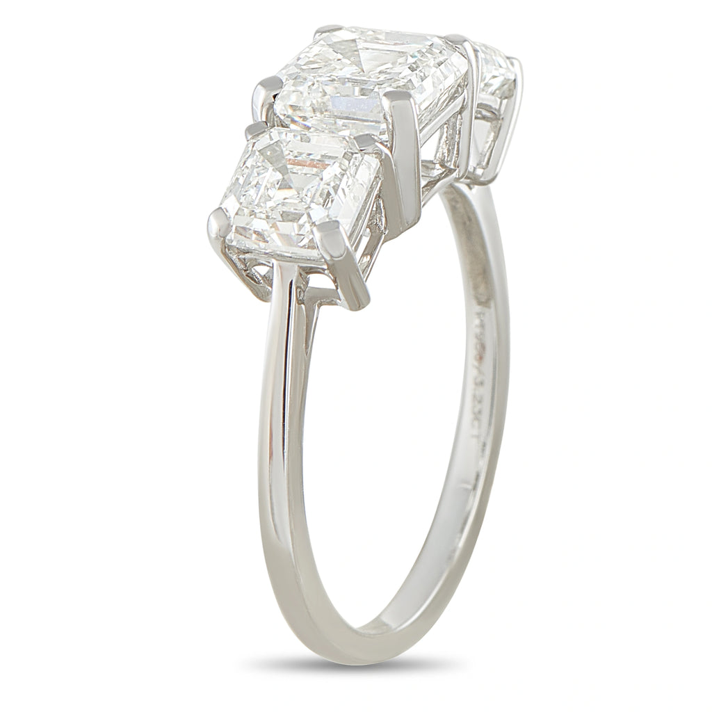 Platinum diamond ring with three stacked emerald-cut stones, side view