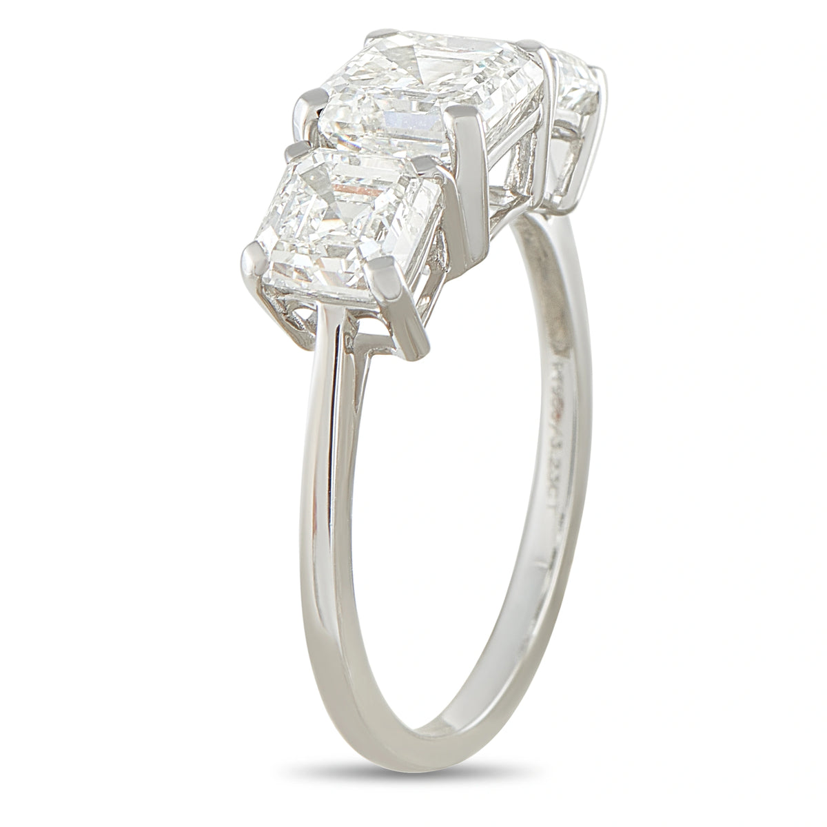 Platinum diamond ring with three stacked emerald-cut stones, side view