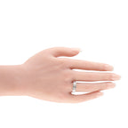Platinum diamond ring on hand, three emerald-cut stones