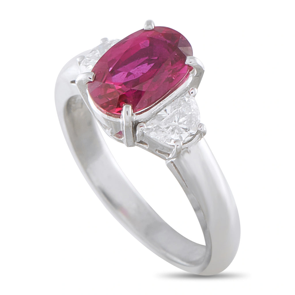 Platinum ruby and diamond ring with an oval red center stone and a polished band