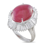 Platinum ring with a large oval ruby cabochon and a halo of baguette-cut diamonds