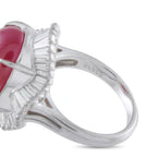 Platinum ring detail showing the ruby setting, baguette diamond halo, and stamped band