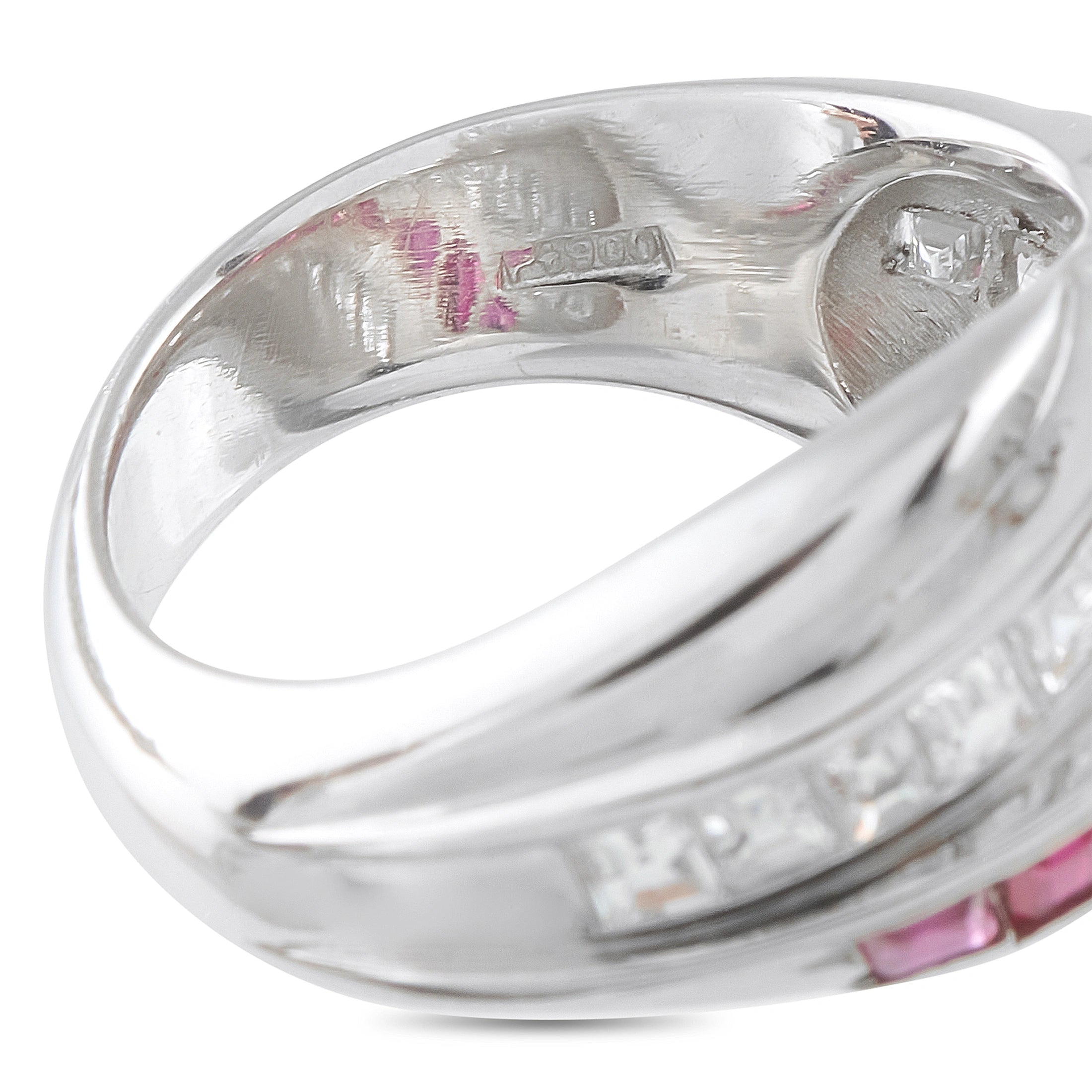 Platinum crossover ring interior with engraved markings and ruby accents