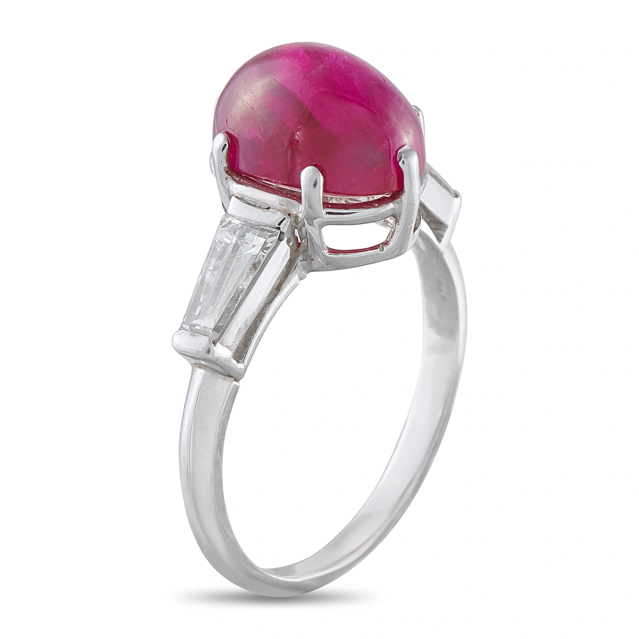 Platinum-toned ring with pink oval cabochon ruby bezel and baguette diamond shoulders