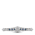 Platinum diamond and sapphire bar brooch with central round stone and blue accents