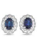 Platinum earrings with dark oval sapphire center and diamond halo, stud style