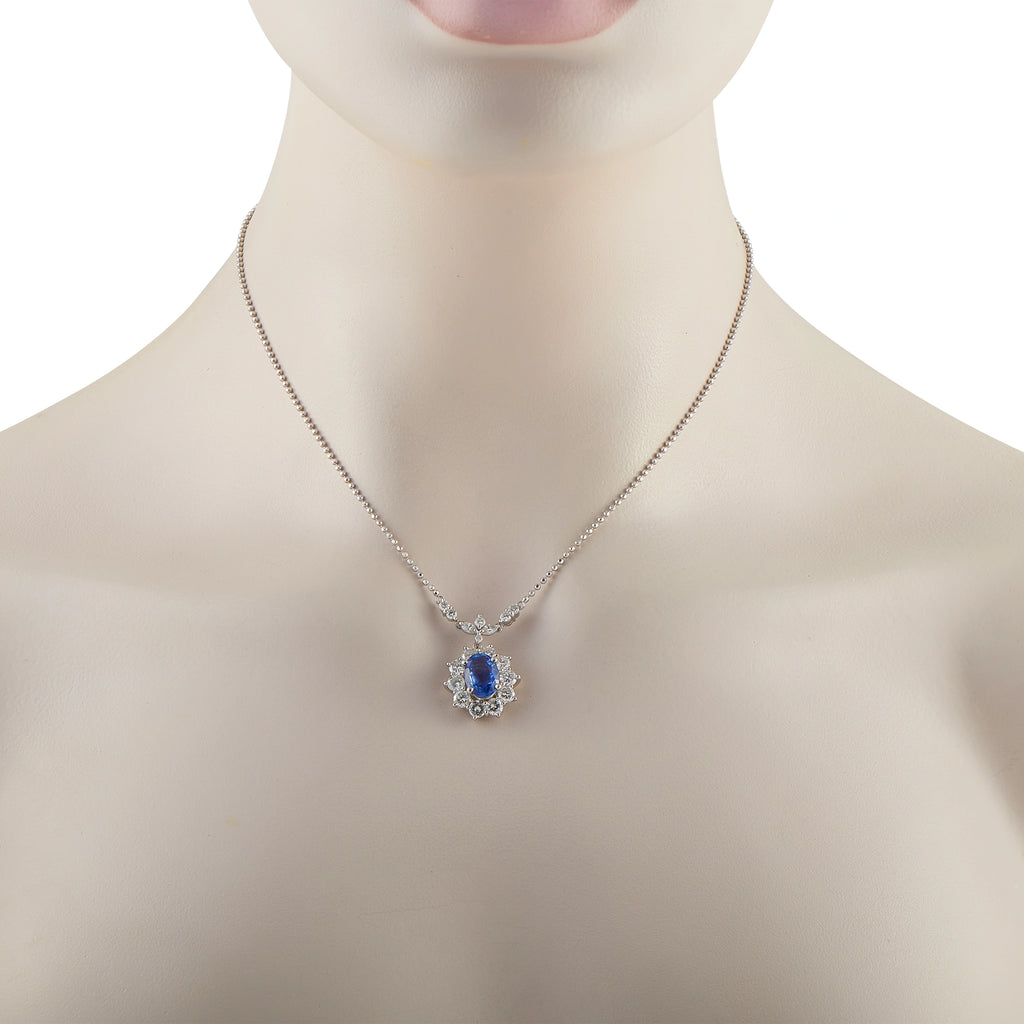 Sapphire and diamond pendant necklace on silver chain with blue center stone