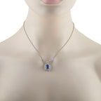 Sapphire and diamond pendant necklace on silver chain with blue center stone