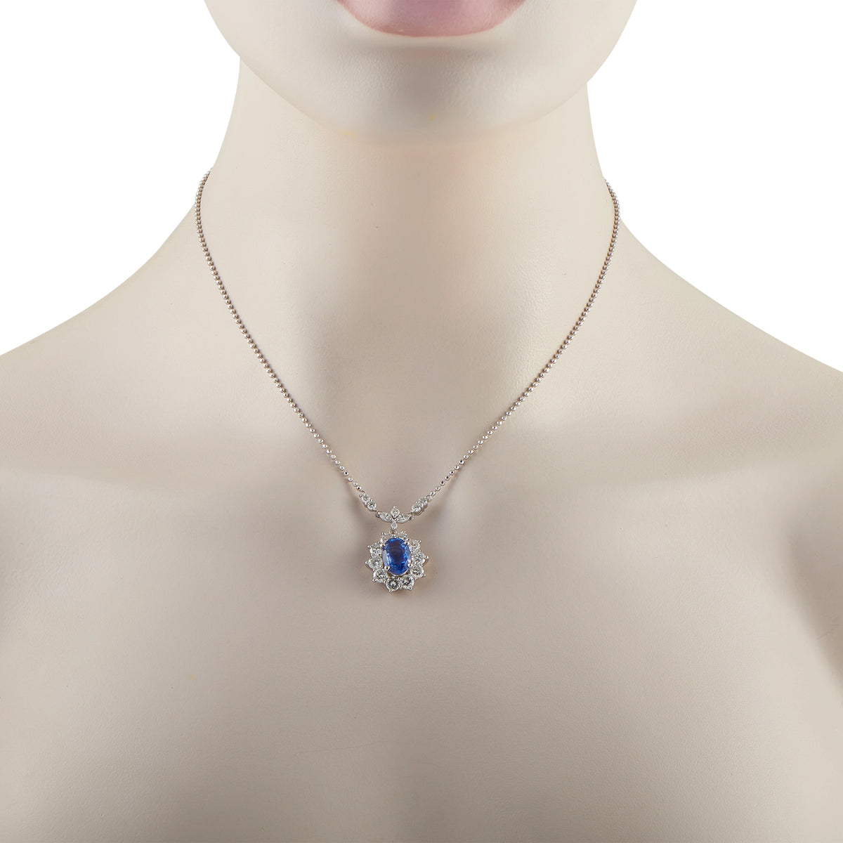 Sapphire and diamond pendant necklace on silver chain with blue center stone