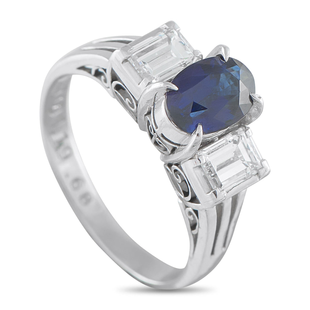 Exclusive Platinum 0.68ct Diamond and Sapphire Three-Stone Ring - This ring’s beauty lives in the contrast of color and brilliance, sharp form, and timeless appeal. It features a 1.19-carat o