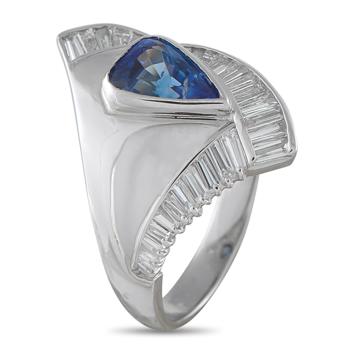 Platinum-tone statement ring with large blue sapphire and diamond baguette side settings