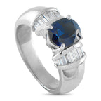 Platinum 0.46ct Diamond and Sapphire Ring - A spectacular 2.18-carat oval sapphire takes center stage, held securely by four classic prongs. Flanking the rich blue cente