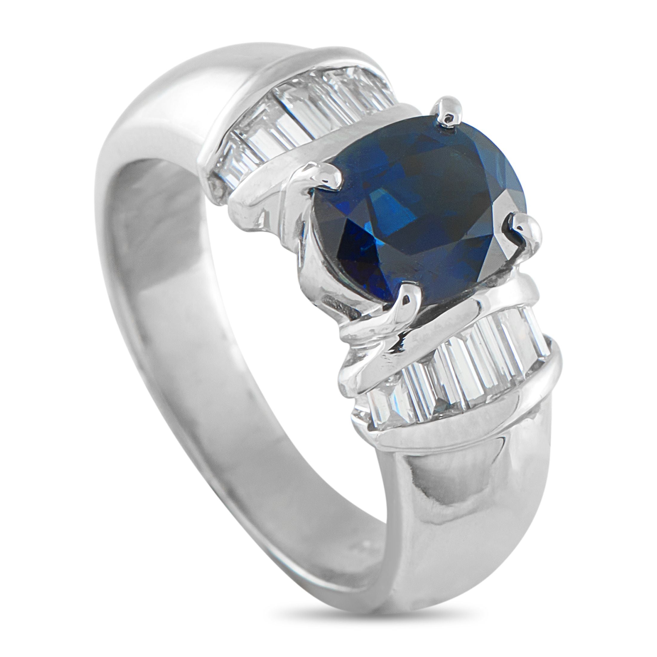 Platinum 0.46ct Diamond and Sapphire Ring - A spectacular 2.18-carat oval sapphire takes center stage, held securely by four classic prongs. Flanking the rich blue cente